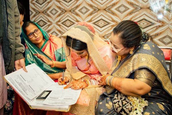 Bride signing her Muslim wedding legal papers pic